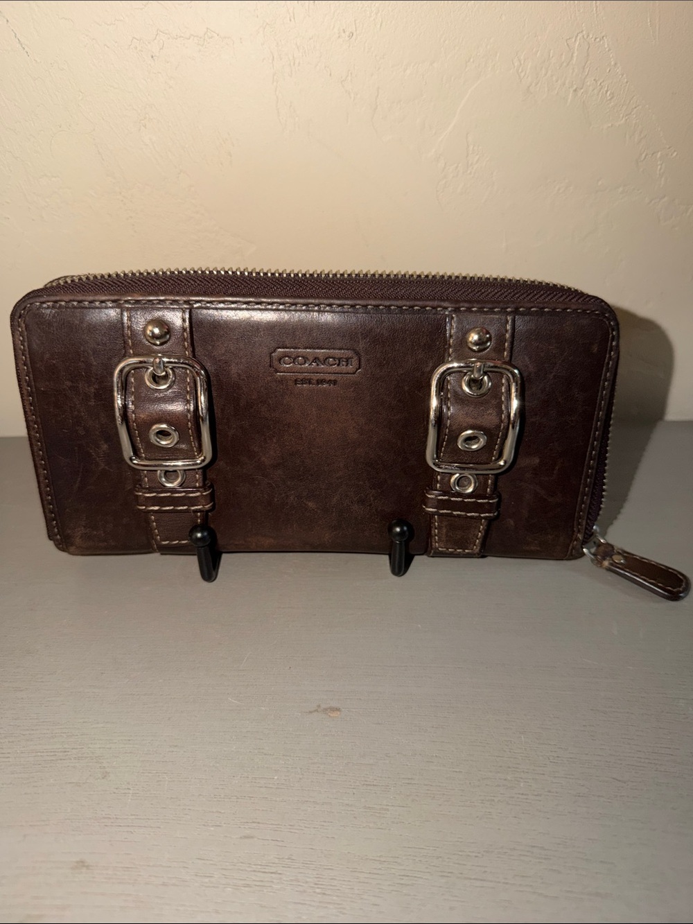 Coach Soho or Zoe dark brown leather double-buckle zip-around wallet
